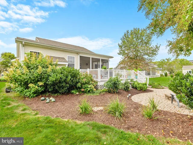 a view of a house with backyard sitting area and garden