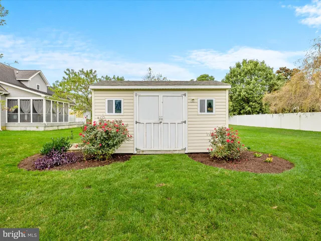 an aerial view of a house with a garden and trees