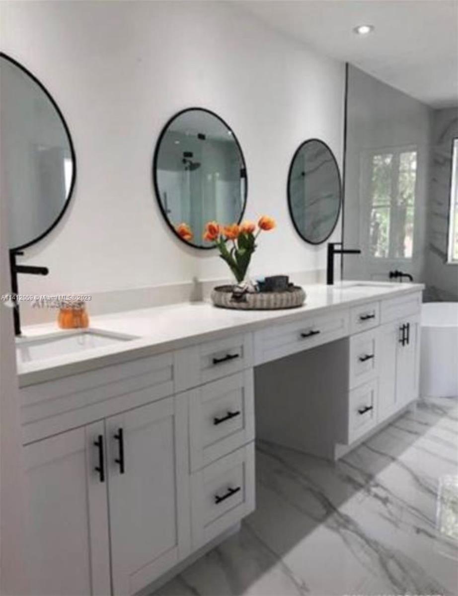 The Hammocks Miami, FL 33196 - Photo 13 of 18 a bathroom with a double vanity sink and a mirror