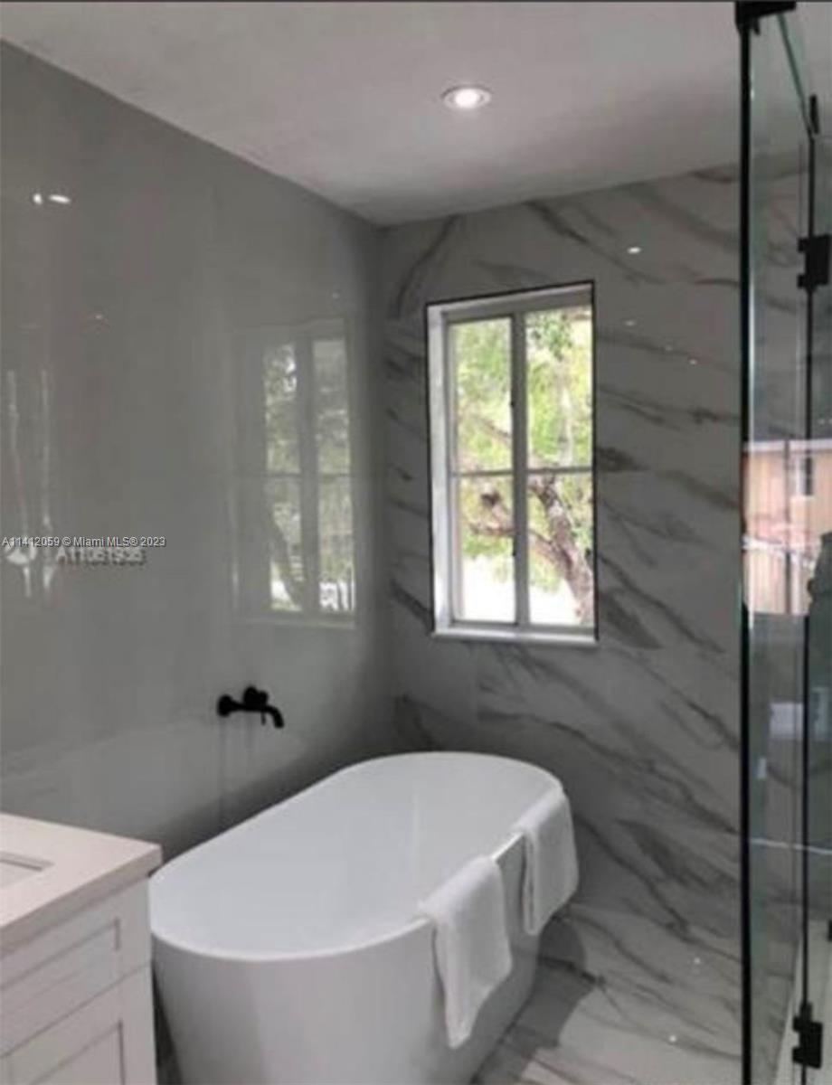 The Hammocks Miami, FL 33196 - Photo 17 of 18 a white bath tub sitting in a bathroom next to a window