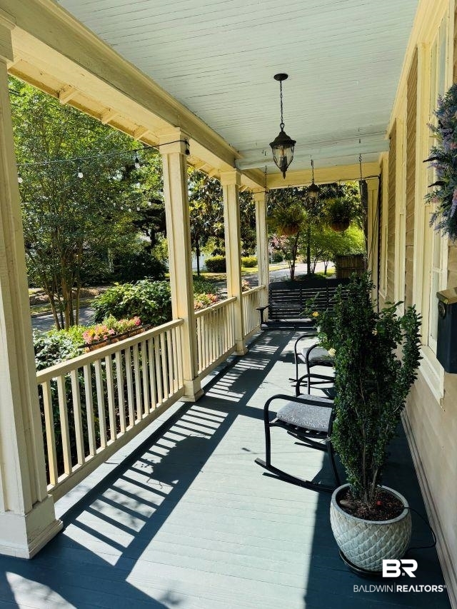 54 South Catherine Street Mobile, AL 36604 - Photo 7 of 55 Welcoming front porch with swing offers view shaded by trees and ornamental plantings
