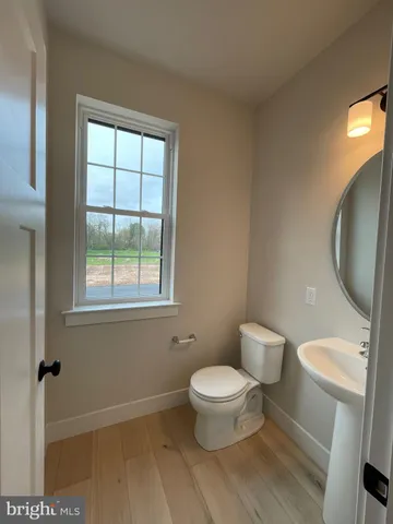a white toilet sitting next to a bathroom sink