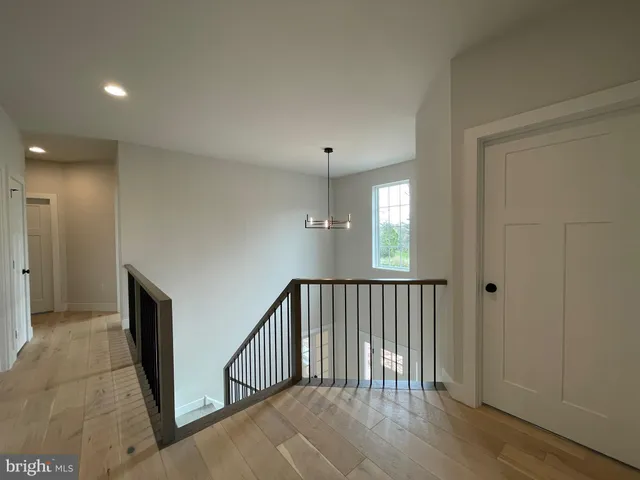 a view of hallway with wooden floor