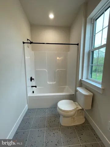a bathroom with a toilet a sink and a shower
