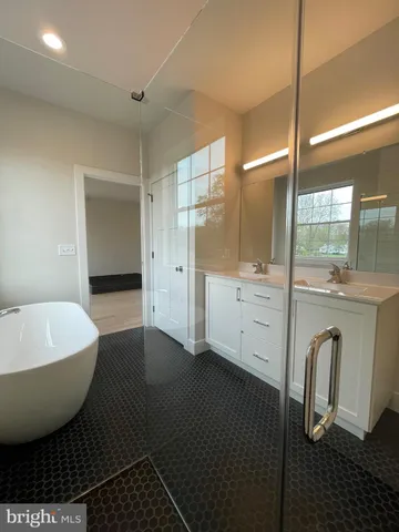 a spacious bathroom with a bathtub and a shower