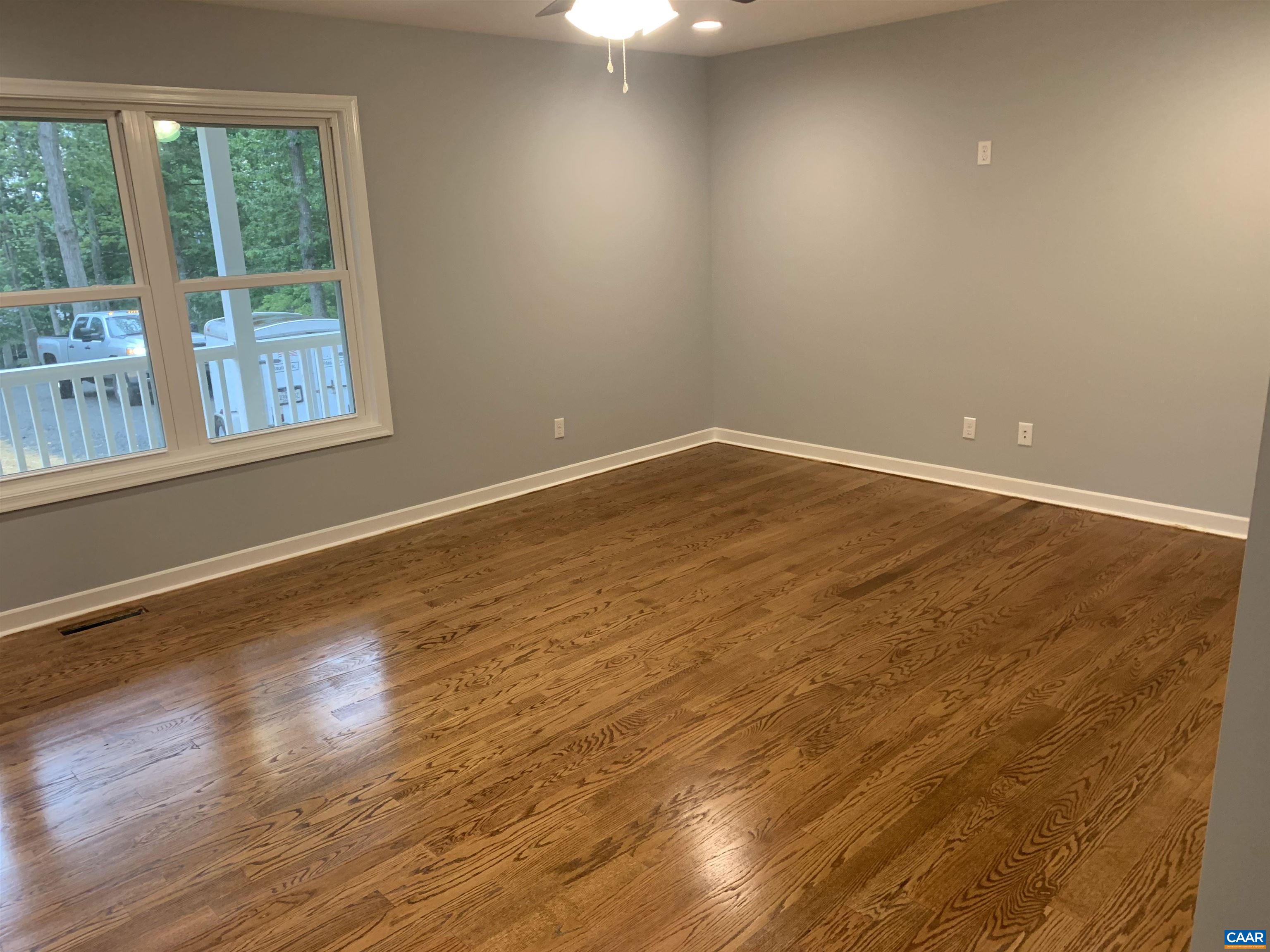 85 Phlox Road Ruckersville, VA 22968 - Photo 5 of 7 a view of an empty room with wooden floor and a window