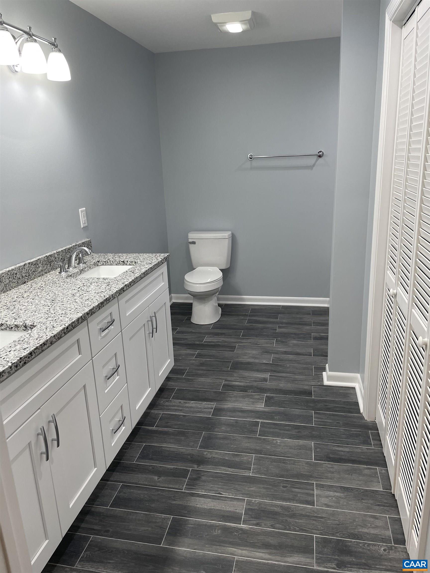 85 Phlox Road Ruckersville, VA 22968 - Photo 6 of 7 a spacious bathroom with a granite countertop sink and a toilet
