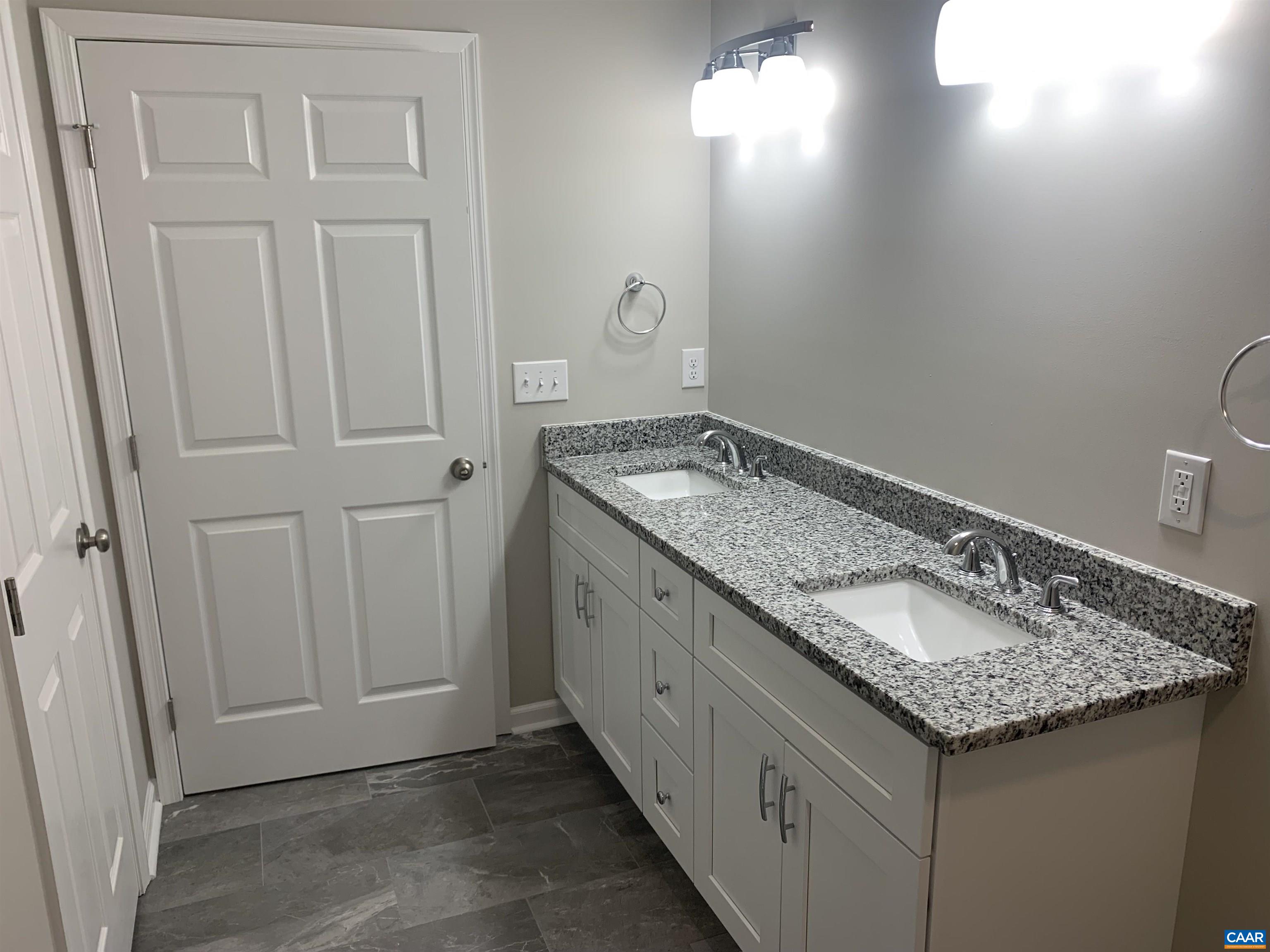 85 Phlox Road Ruckersville, VA 22968 - Photo 7 of 7 a bathroom with a granite countertop sink and a mirror