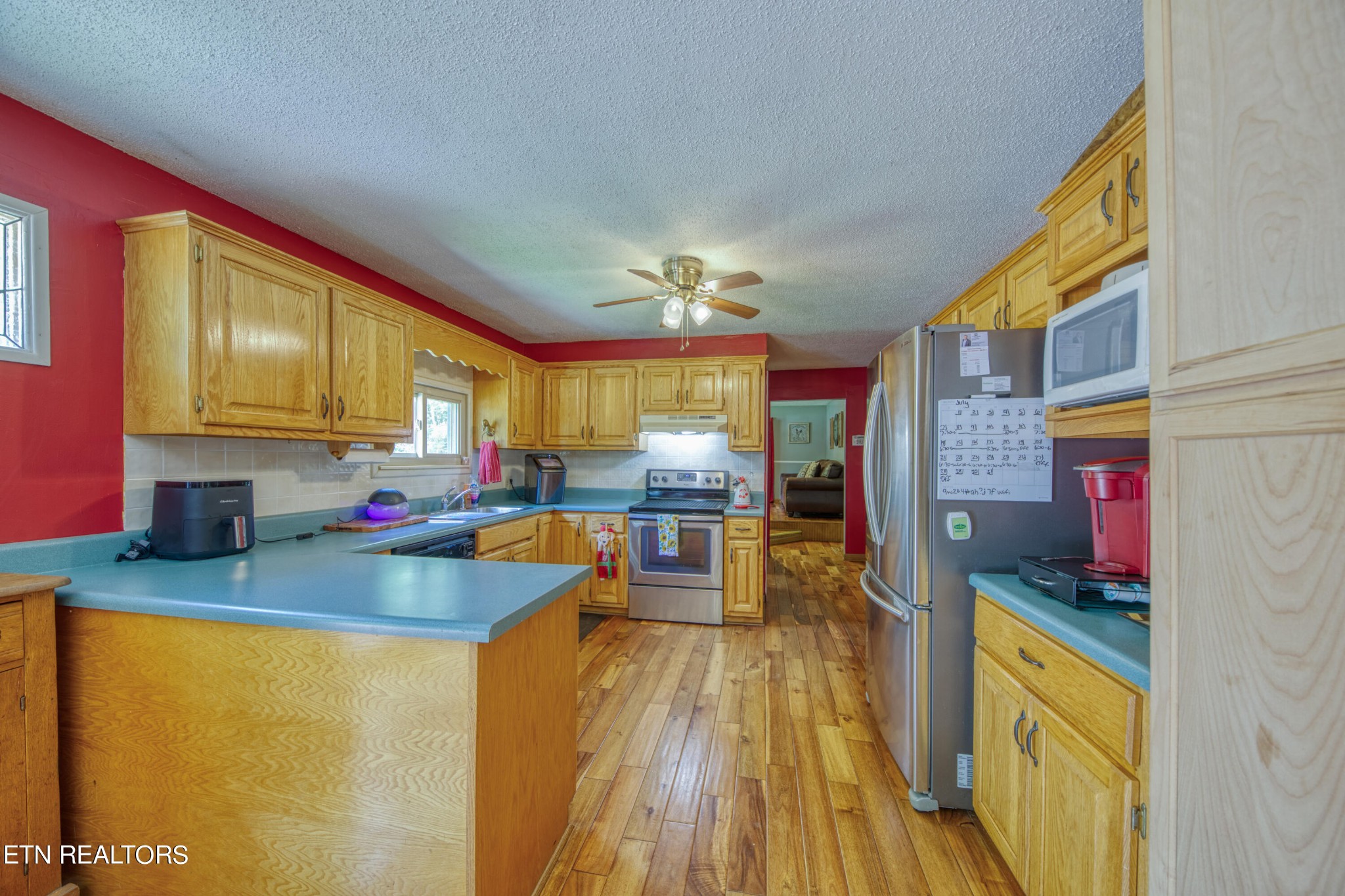 713 Pine Ridge Road Clinton, TN 37716 - Photo 8 of 57 a kitchen view with wooden floor and stainless steel appliances