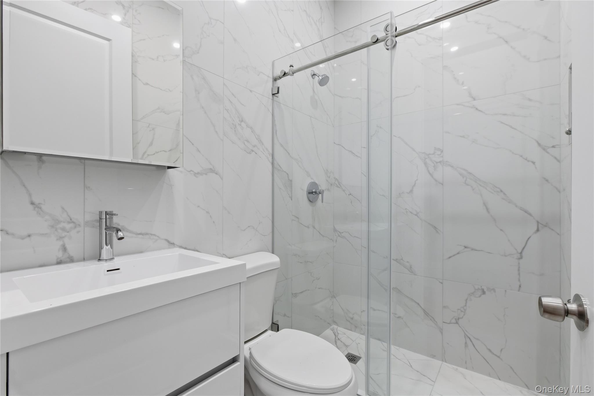 99 Main Street, Unit 2B Brewster, NY 10509 - Photo 6 of 11 a bathroom with a sink toilet and shower