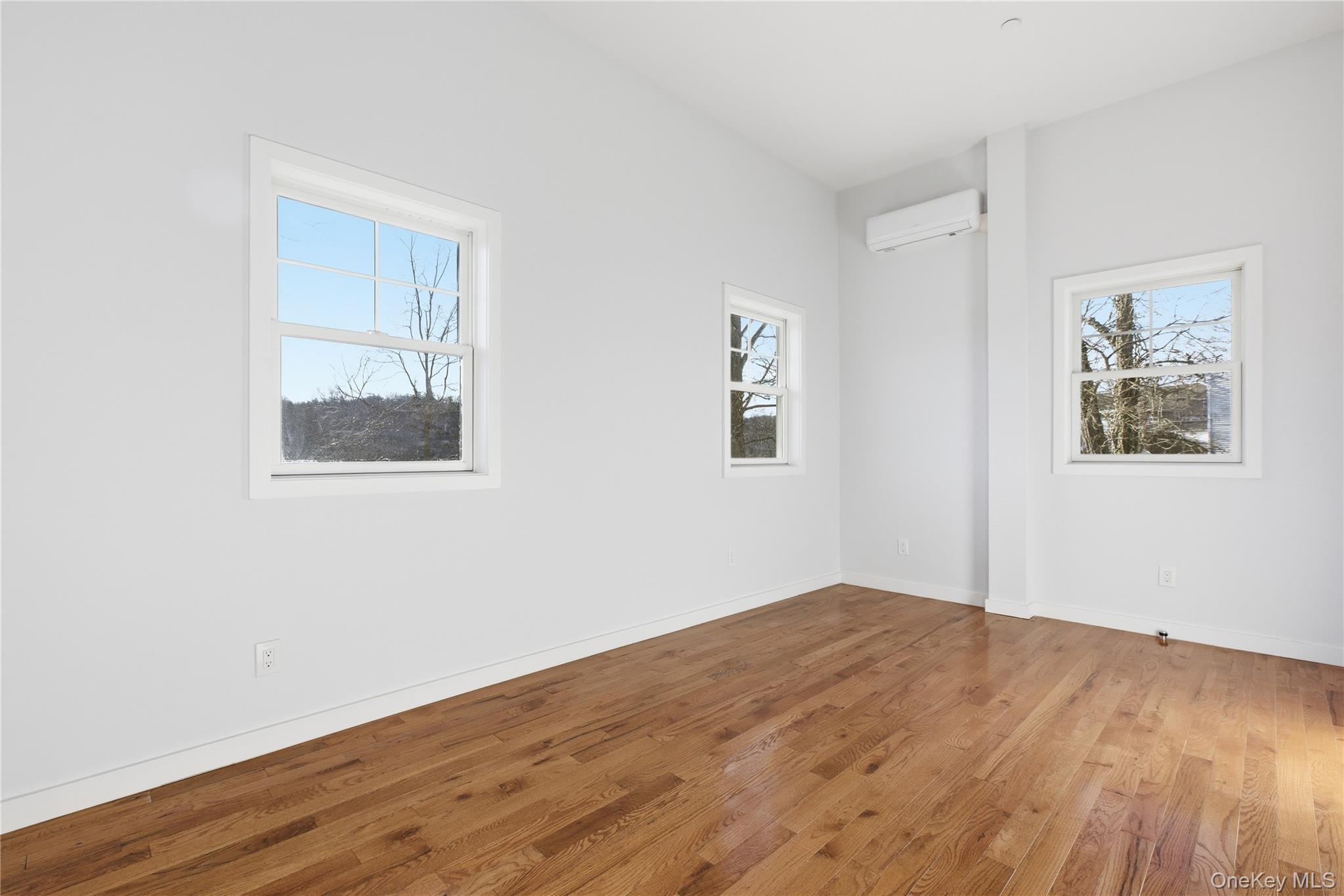 99 Main Street, Unit 2B Brewster, NY 10509 - Photo 8 of 11 a view of empty room with wooden floor and fan