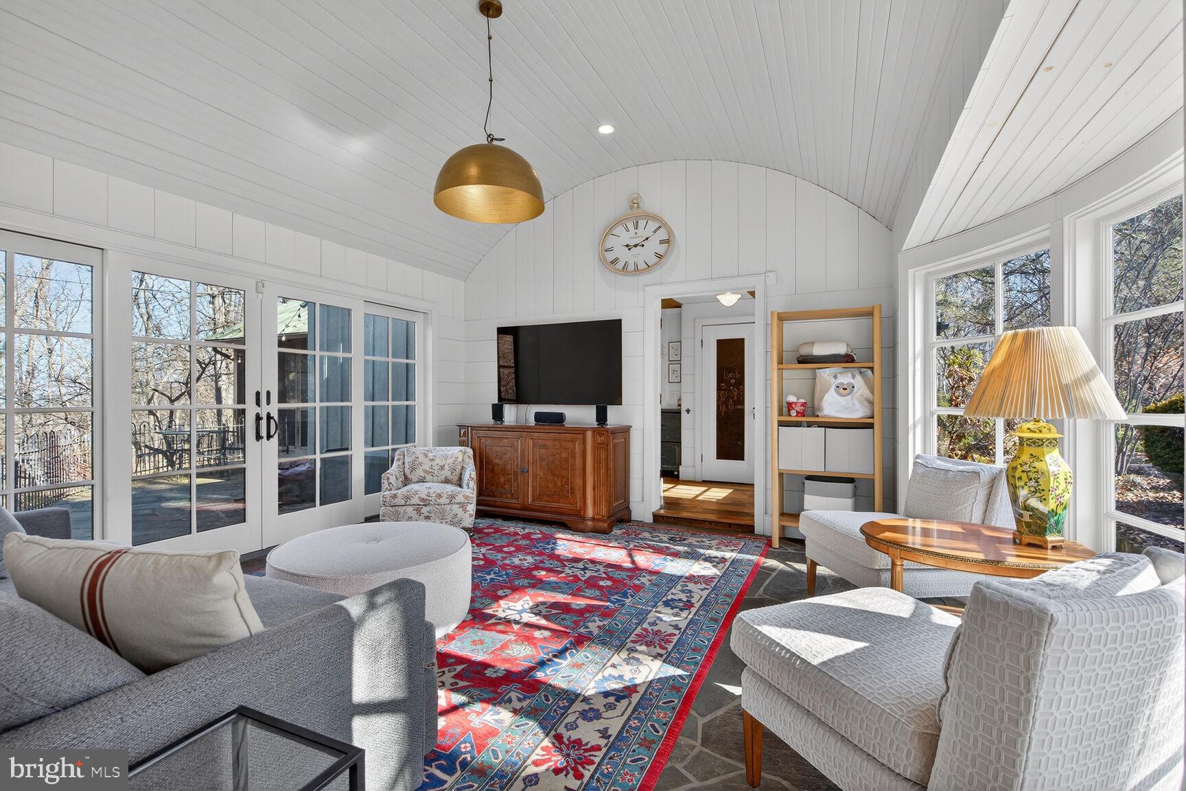a living room with furniture a flat screen tv and a table