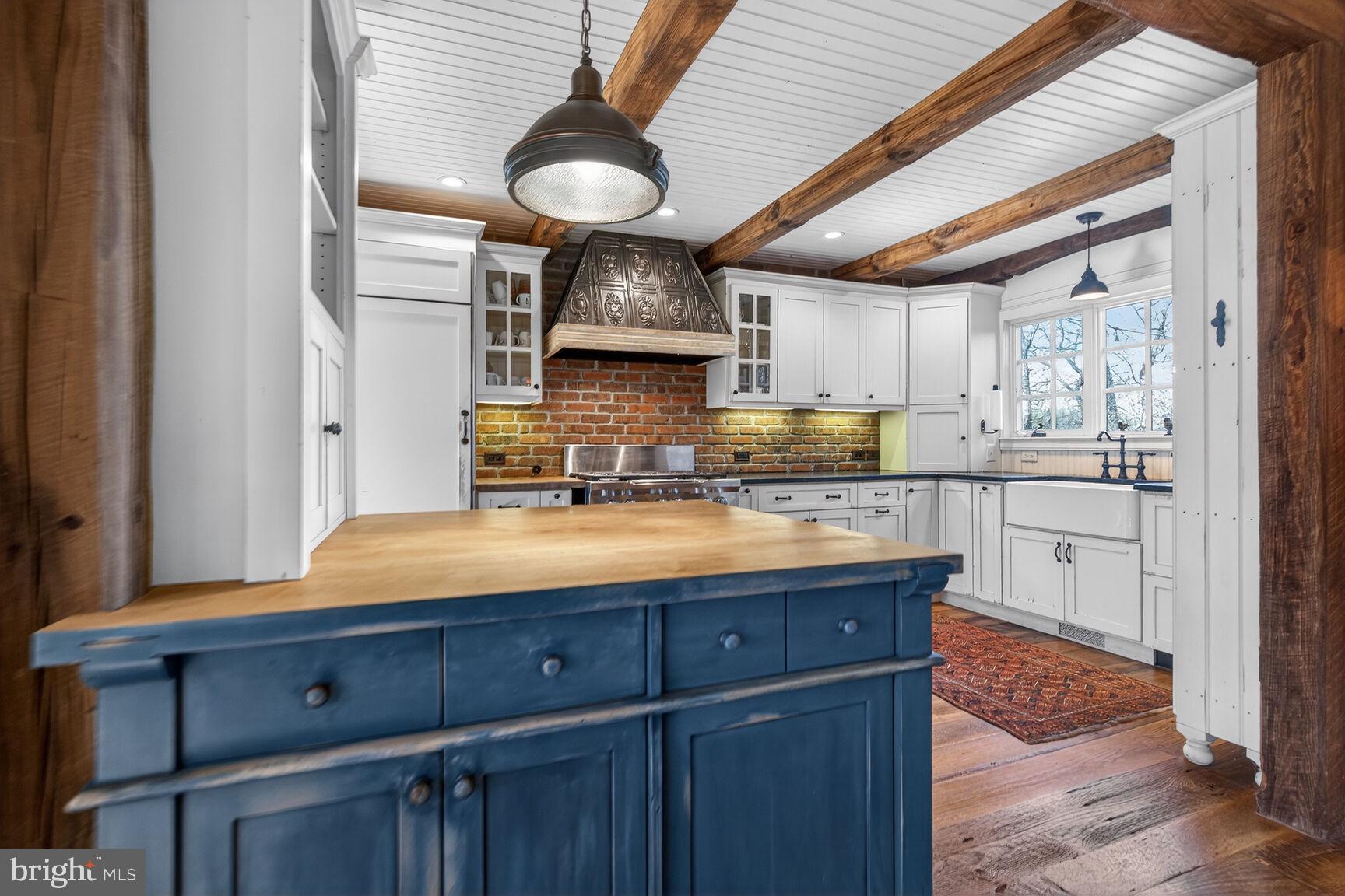17651 Raven Rocks Road Bluemont, VA 20135 - Photo 13 of 87 a kitchen with kitchen island granite countertop wooden cabinets and white appliances