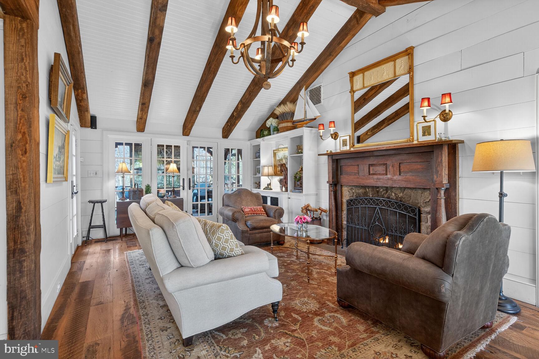 17651 Raven Rocks Road Bluemont, VA 20135 - Photo 16 of 87 a living room with furniture a fireplace and a chandelier