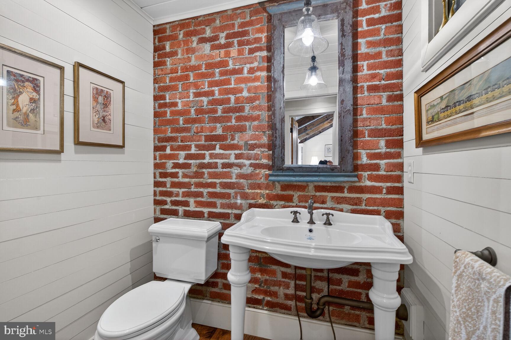 17651 Raven Rocks Road Bluemont, VA 20135 - Photo 30 of 87 a bathroom with a sink a toilet and mirror