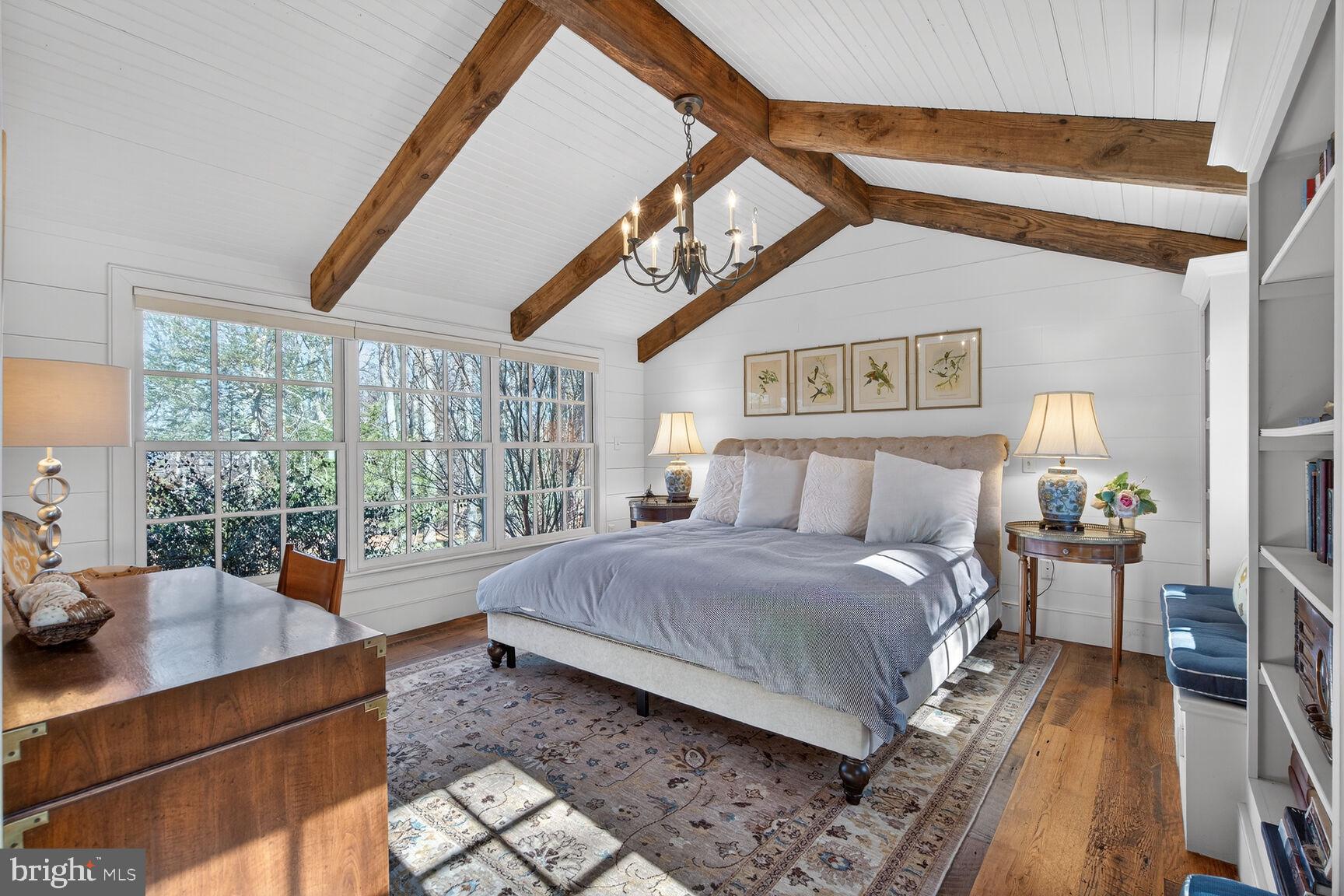 17651 Raven Rocks Road Bluemont, VA 20135 - Photo 31 of 87 a spacious bedroom with a bed a chandelier and large window