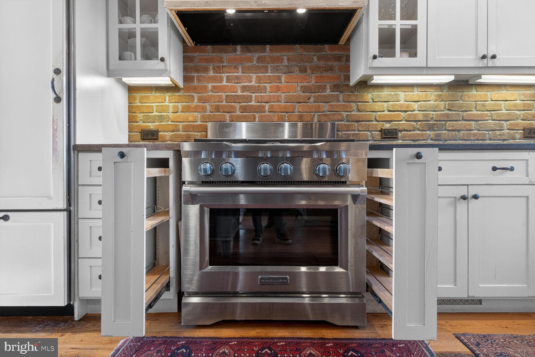 17651 Raven Rocks Road Bluemont, VA 20135 - Photo 10 of 87 a kitchen with stainless steel appliances kitchen island wooden cabinets and a counter top space