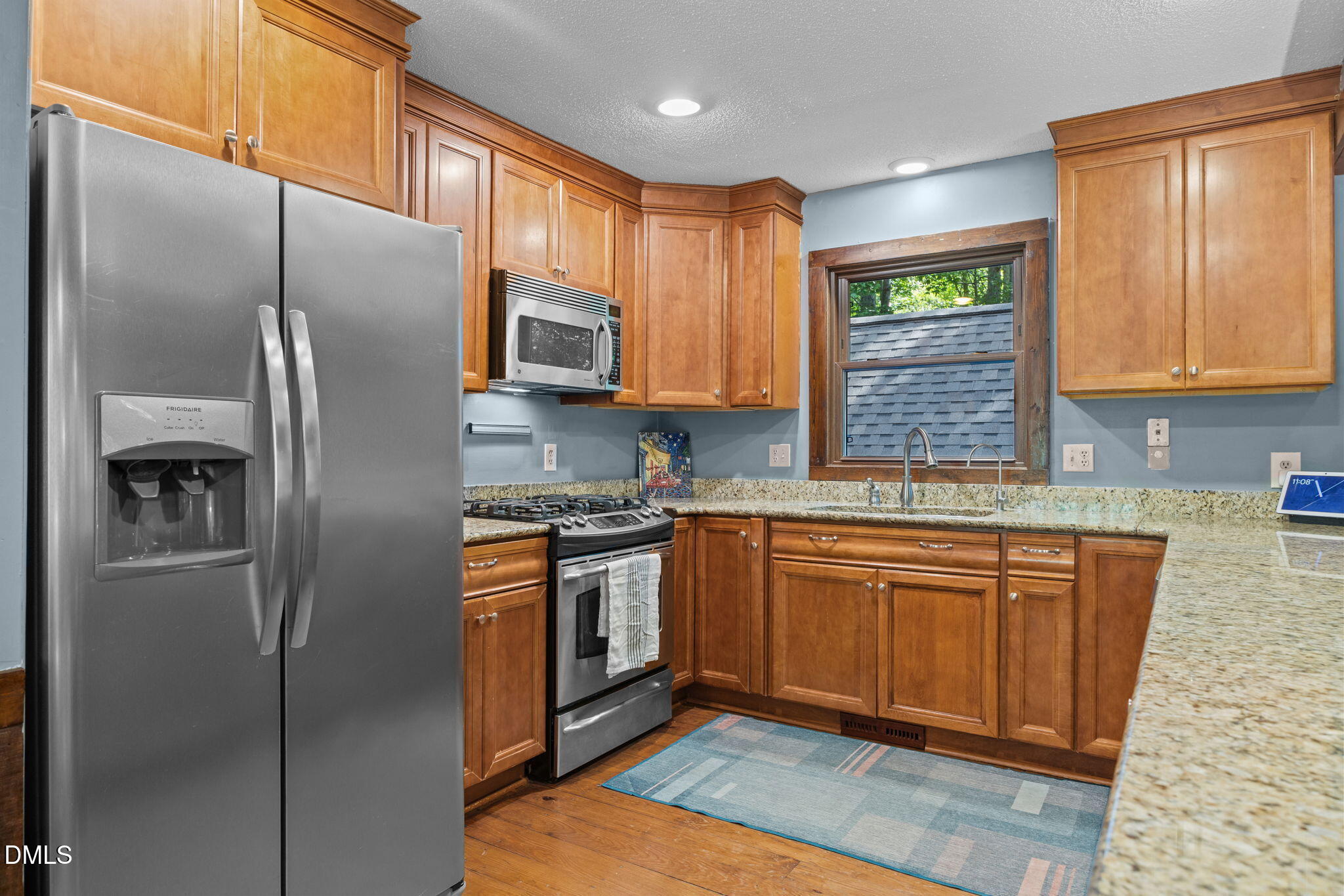 2408 Windsor Trail Raleigh, NC 27615 - Photo 10 of 45 a kitchen with stainless steel appliances granite countertop a refrigerator a sink dishwasher a stove with wooden cabinets and floor