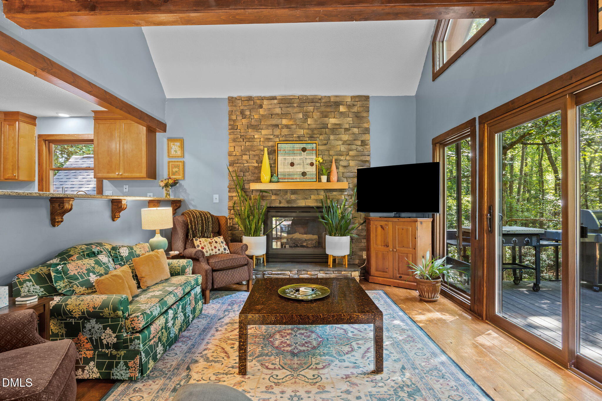 2408 Windsor Trail Raleigh, NC 27615 - Photo 14 of 45 a living room with furniture a flat screen tv and a floor to ceiling window