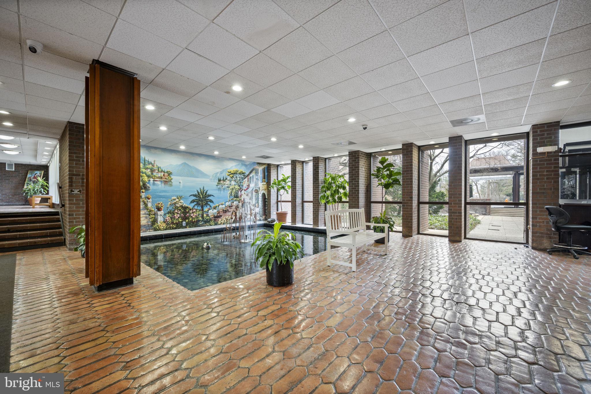 7 Slade Avenue, Unit 119 Baltimore, MD 21208 - Photo 4 of 41 Lobby with pond