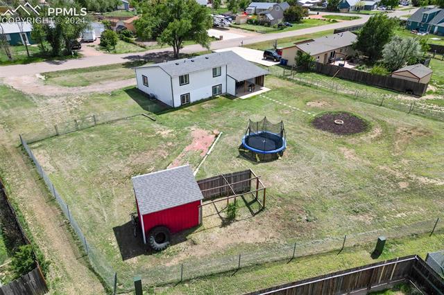 10840 Falling Star Road Fountain, CO 80817 - Photo 11 of 12 Another aerial view of the fenced yard, storage shed, BBQ pit and nice home.