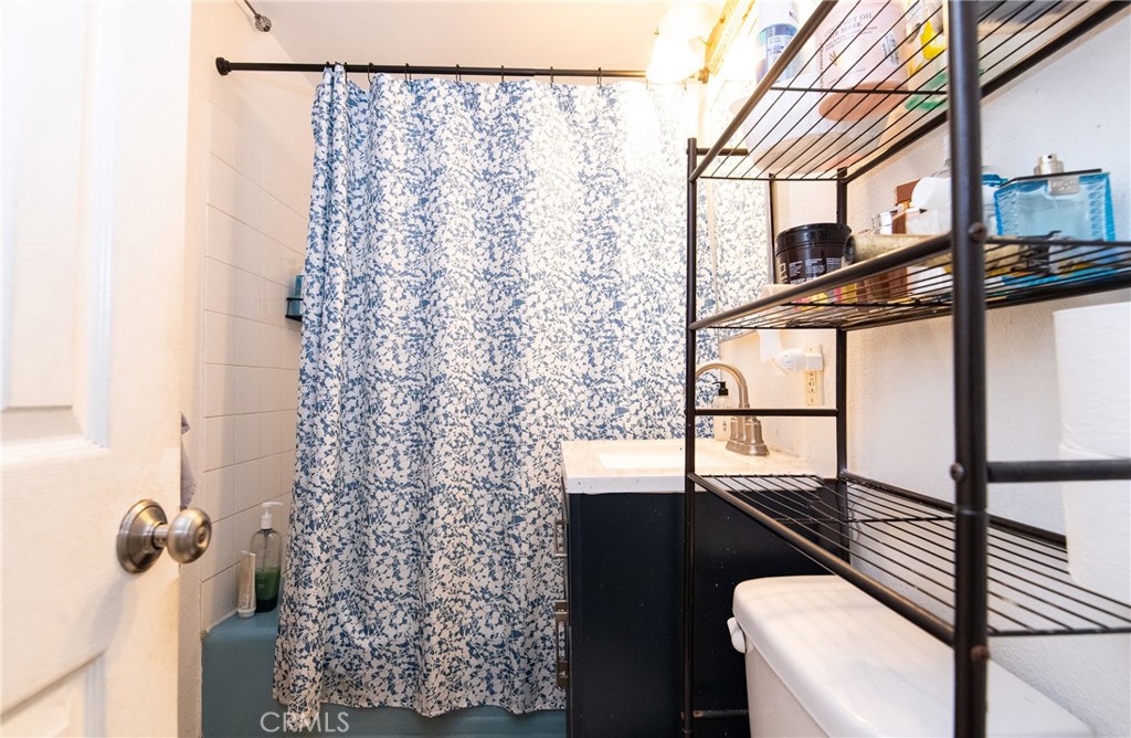 9814 Bandera Street Los Angeles, CA 90002 - Photo 11 of 15 a view of a balcony with wooden floor and chair