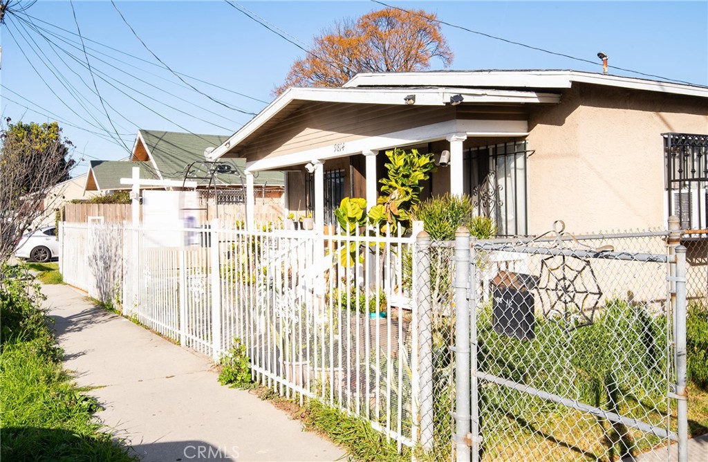 9814 Bandera Street Los Angeles, CA 90002 - Photo 3 of 15 a view of a house with a small yard