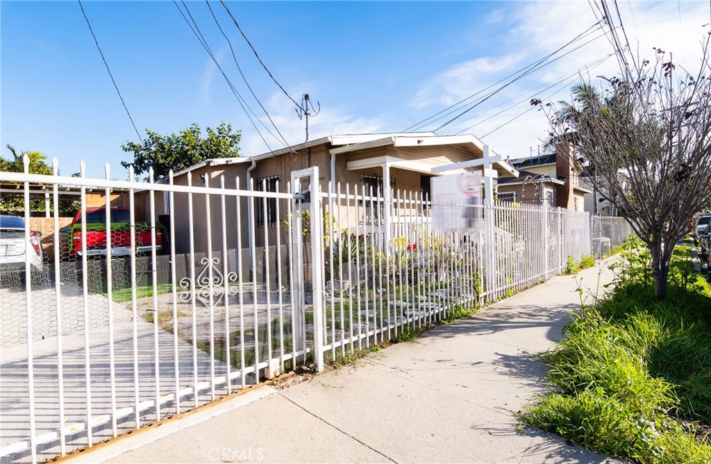 9814 Bandera Street Los Angeles, CA 90002 - Photo 4 of 15 a view of a wrought iron fences in front of house