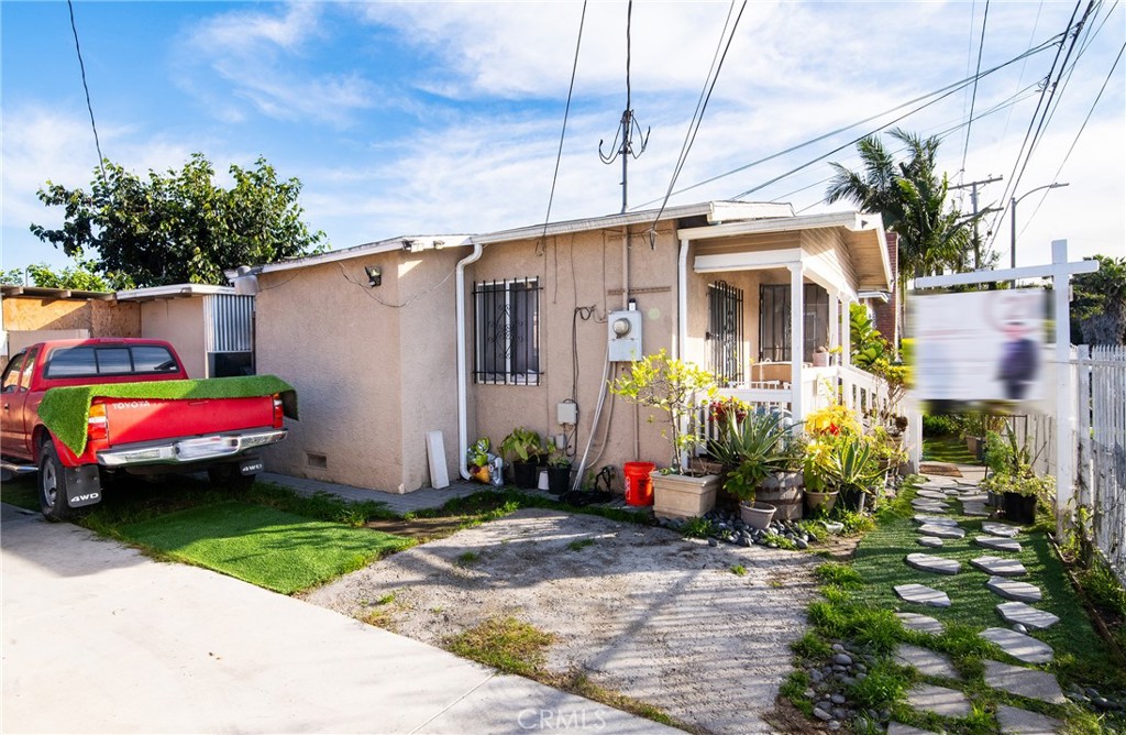 9814 Bandera Street Los Angeles, CA 90002 - Photo 5 of 15 a front view of a house with a yard