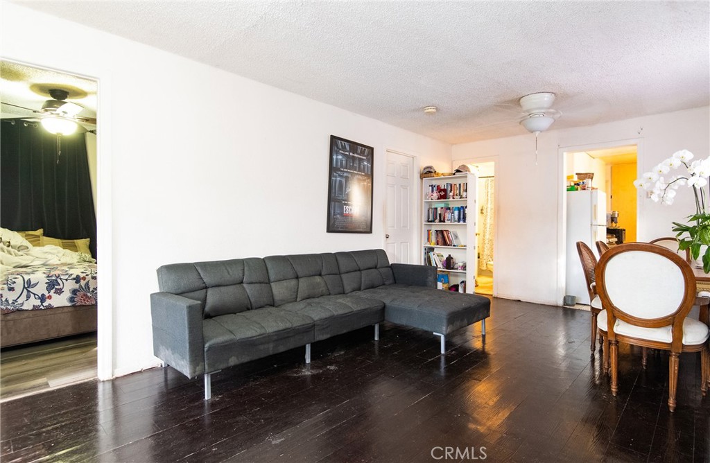 9814 Bandera Street Los Angeles, CA 90002 - Photo 6 of 15 a living room with furniture a flat screen tv and a table