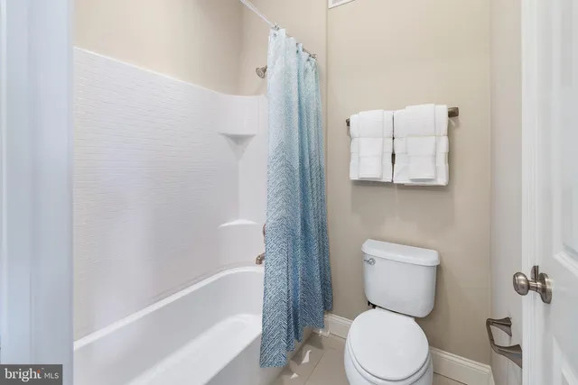 a white toilet sitting next to a bath tub