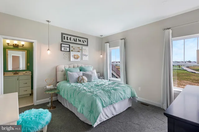 a bedroom with a bed and a view of bathroom