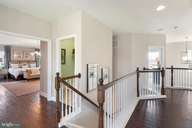 a view of a livingroom with wooden floor and stairs