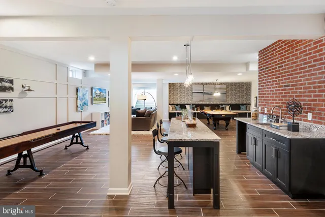 a kitchen with stainless steel appliances kitchen island hardwood floor sink and stove