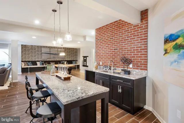 a kitchen with a table chairs and white cabinets