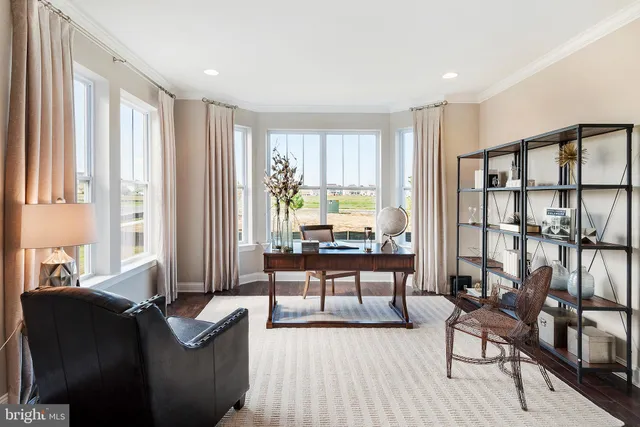a living room with furniture and large windows