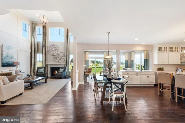 a living room with fireplace furniture and a wooden floor