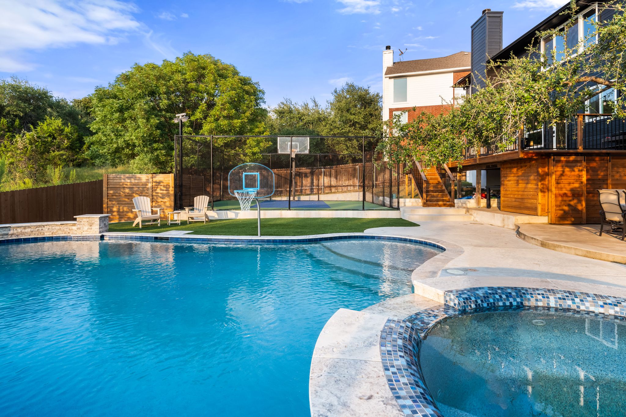 2204 Rimrock Drive Austin, TX 78738 - Photo 32 of 39 An inviting swimming pool and integrated spa sit adjacent to a backyard basketball court.