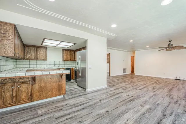 a view of a kitchen with a sink and wooden floor