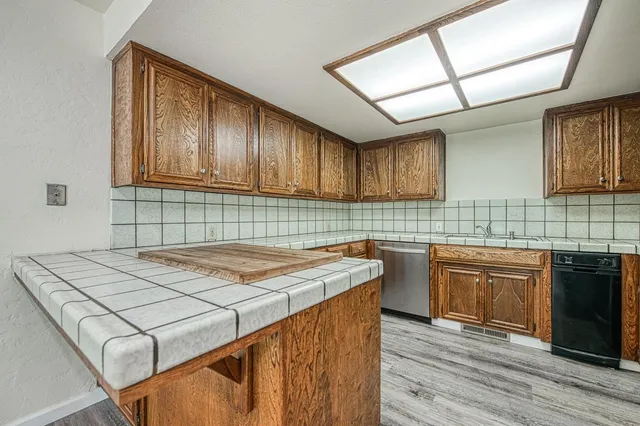 a kitchen with a stove sink and cabinets