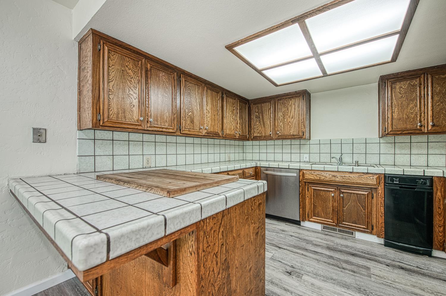 33988 Shaver Springs Road Auberry, CA 93602 - Photo 16 of 34 a kitchen with a stove sink and cabinets
