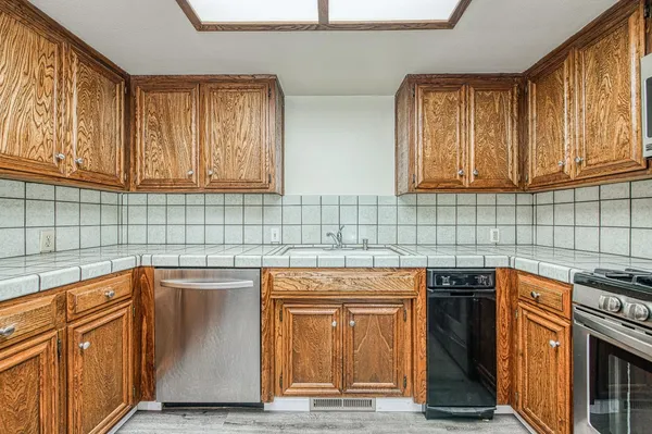 a kitchen with stainless steel appliances granite countertop a sink and cabinets