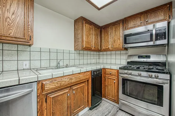 a kitchen with stainless steel appliances granite countertop a stove and a microwave