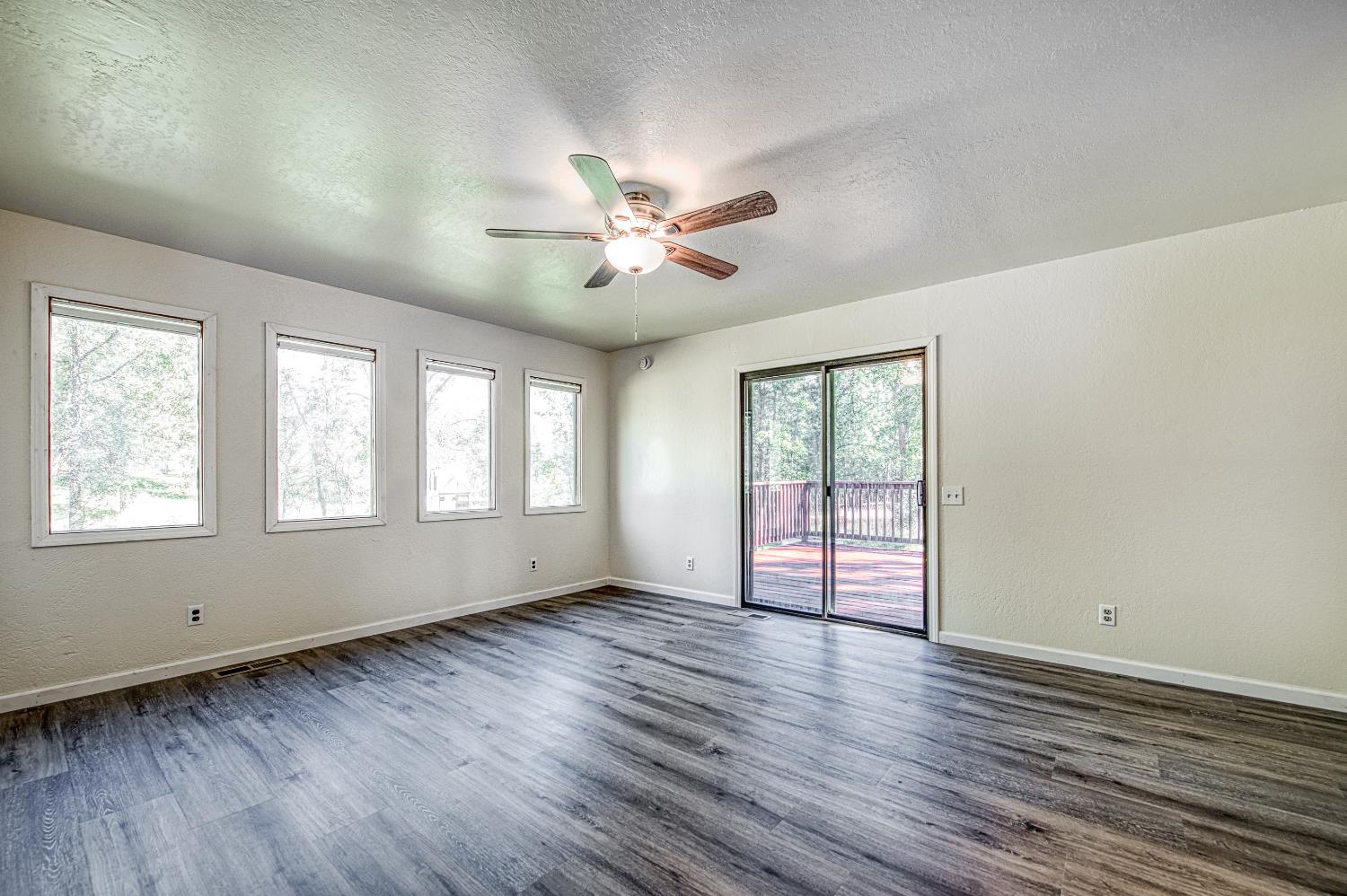 33988 Shaver Springs Road Auberry, CA 93602 - Photo 20 of 34 a view of an empty room with wooden floor and a window