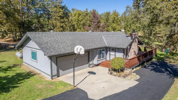 an aerial view of a house with a yard