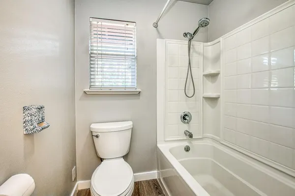 a bathroom with a toilet sink and shower