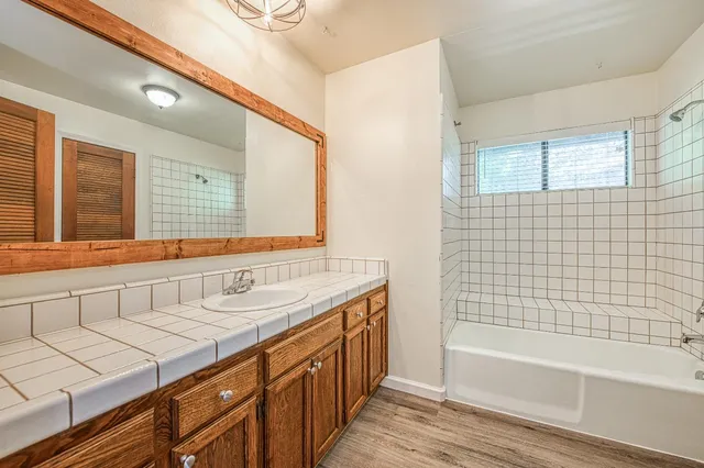 a bathroom with a sink a mirror and a bathtub