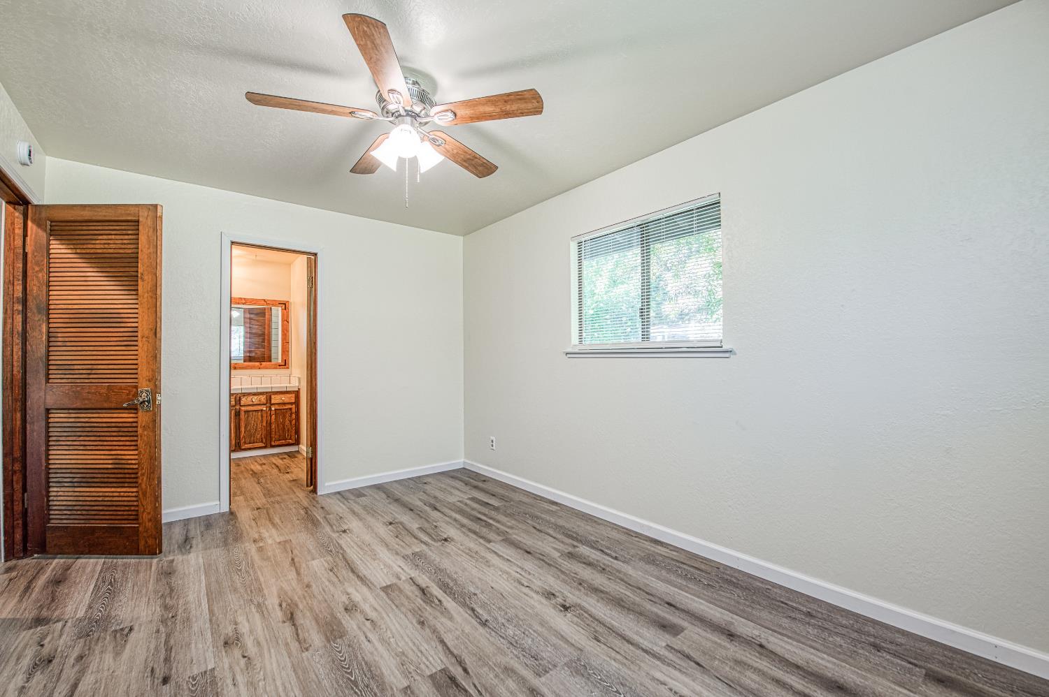 33988 Shaver Springs Road Auberry, CA 93602 - Photo 28 of 34 wooden floor in an empty room with a window