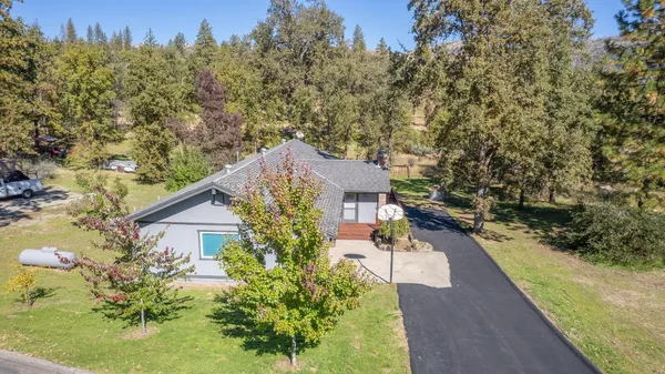 a view of a house with a yard and garden