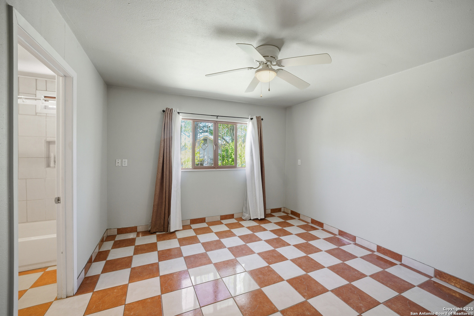 406 North Rancho Road Nixon, TX 78140 - Photo 13 of 31 a bedroom with a bed and a black mirror